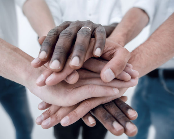 multiple hands on each other