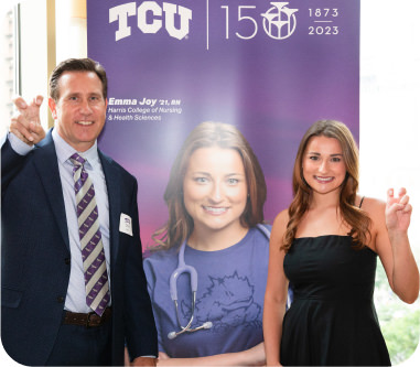 Dean Watts poses with Emma Joy '21 at the event celebrating the installation of TCU's 150th anniversary mural in Chicago.