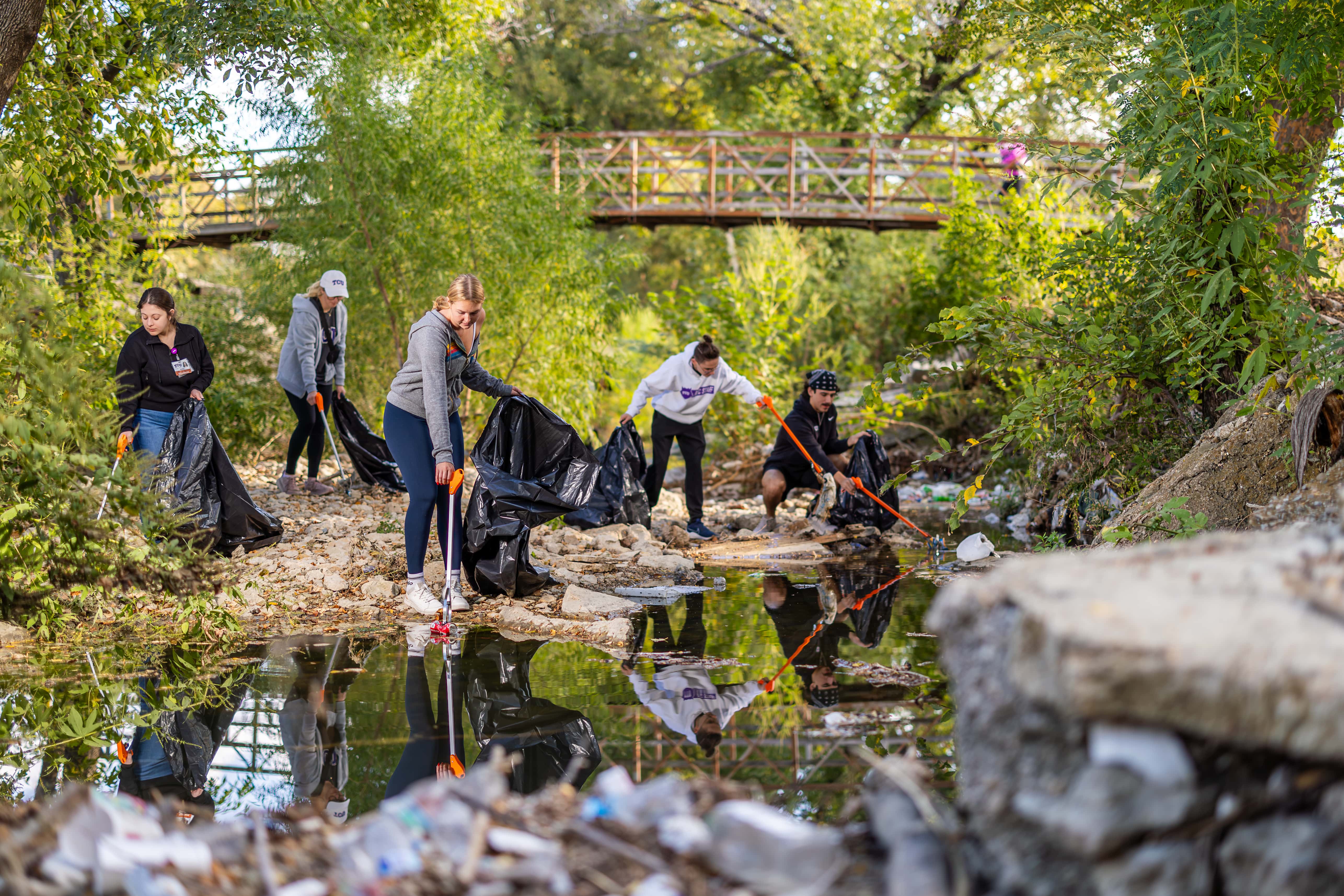 TCU students picking up garbage in Glenwood Park.
