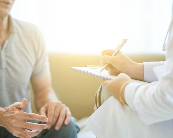 Patient talking to doctor taking notes