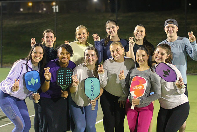 Students posing for group photo at a pickleball event