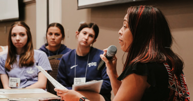 Faculty member speaking during a poverty lab simulation