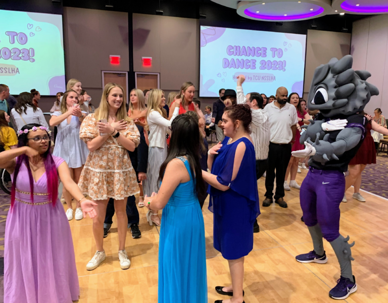 Guests at the TCU chapter of the NSSLHA’s Chance to Dance event on the dance floor with SuperFrog