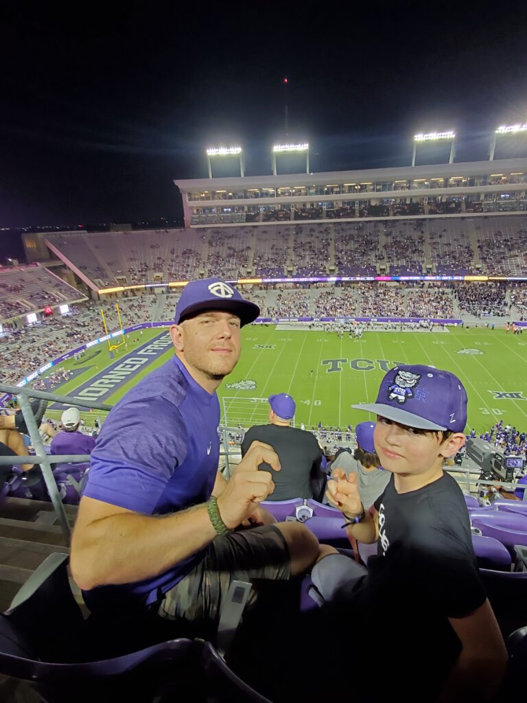 Arrow and his son attending a TCU football game at Amon G. Carter Stadium