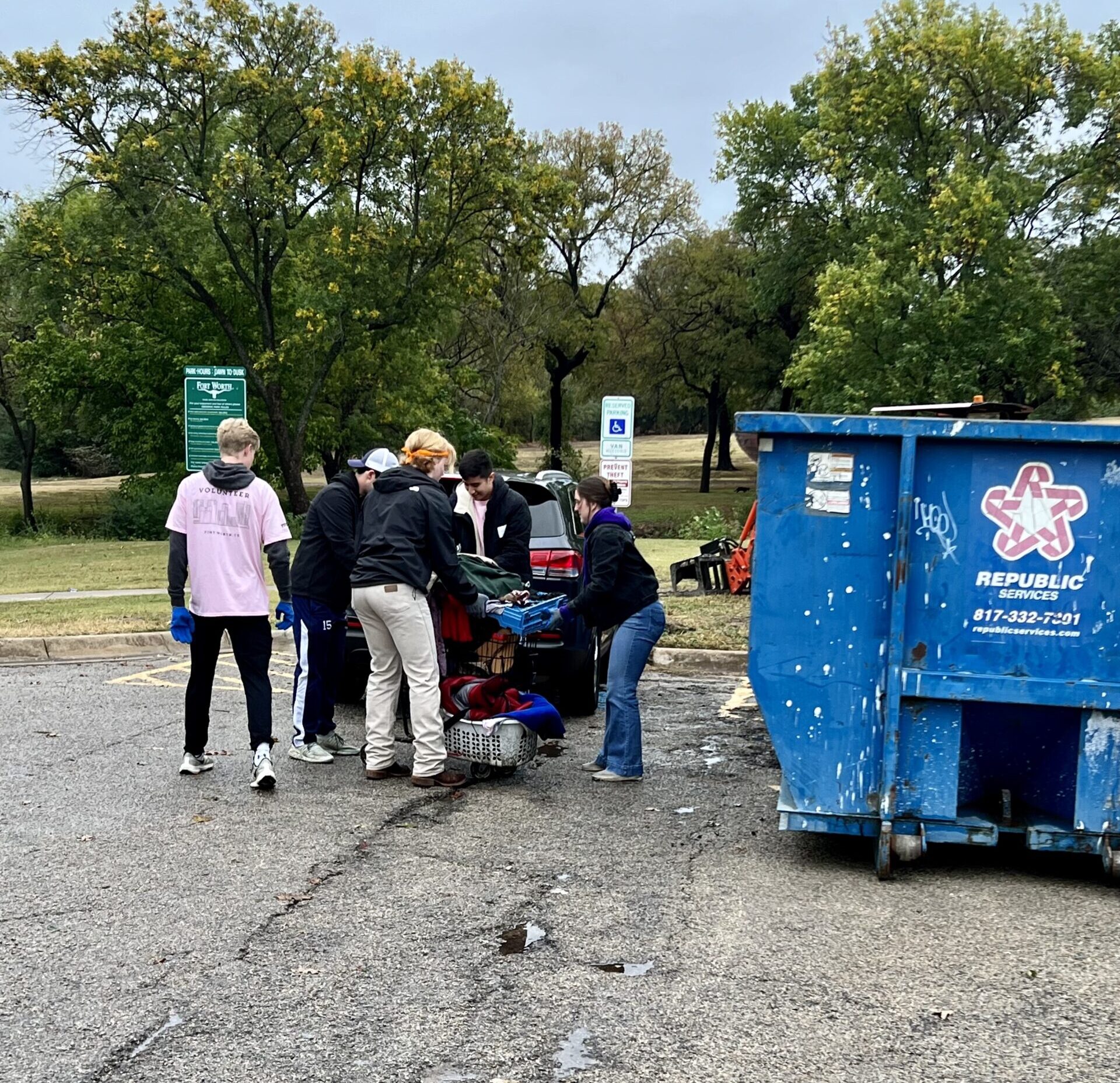 TCU students disposing of large trash items found in the park