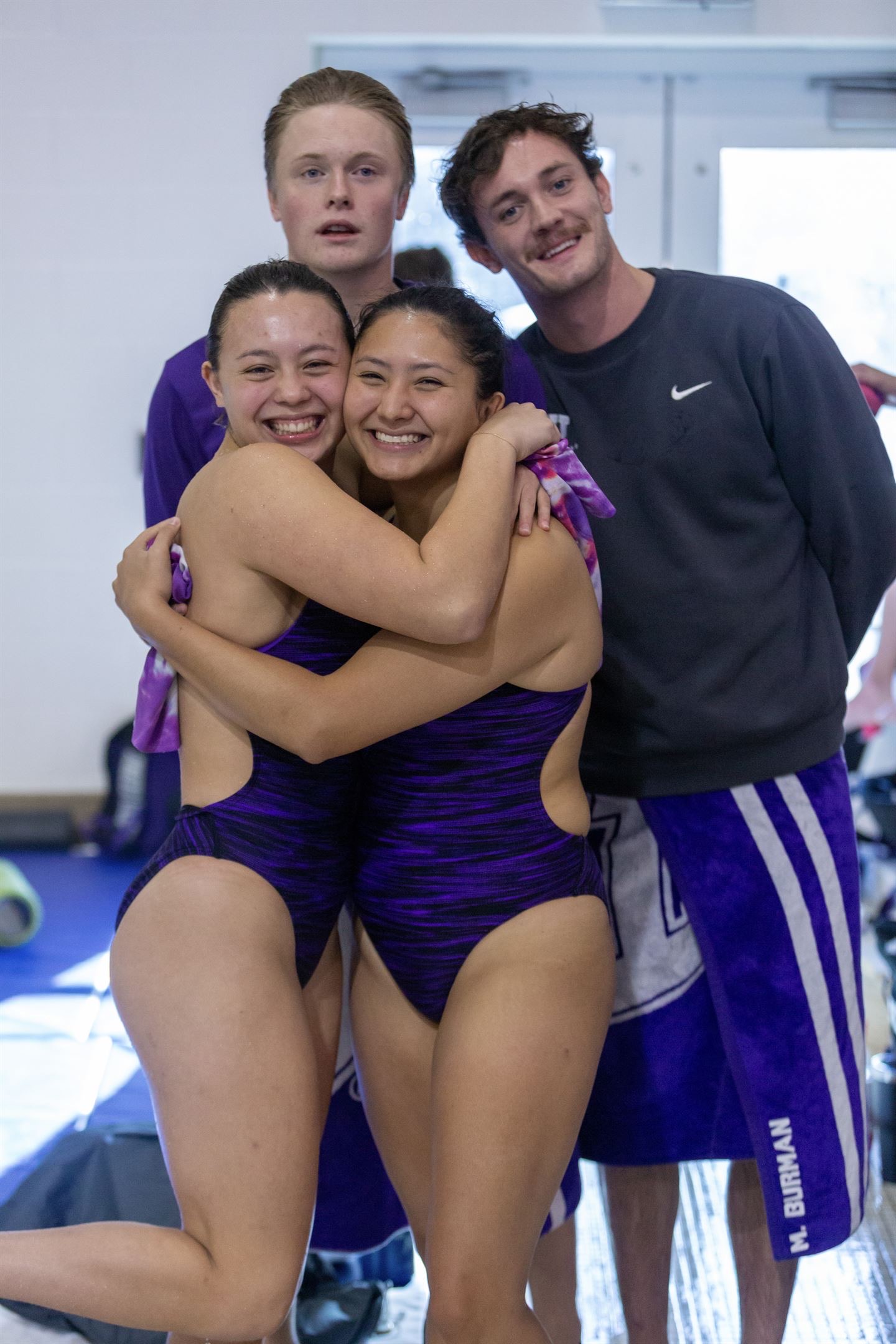 Gracie and her teammates hugging after a swim and dive competition