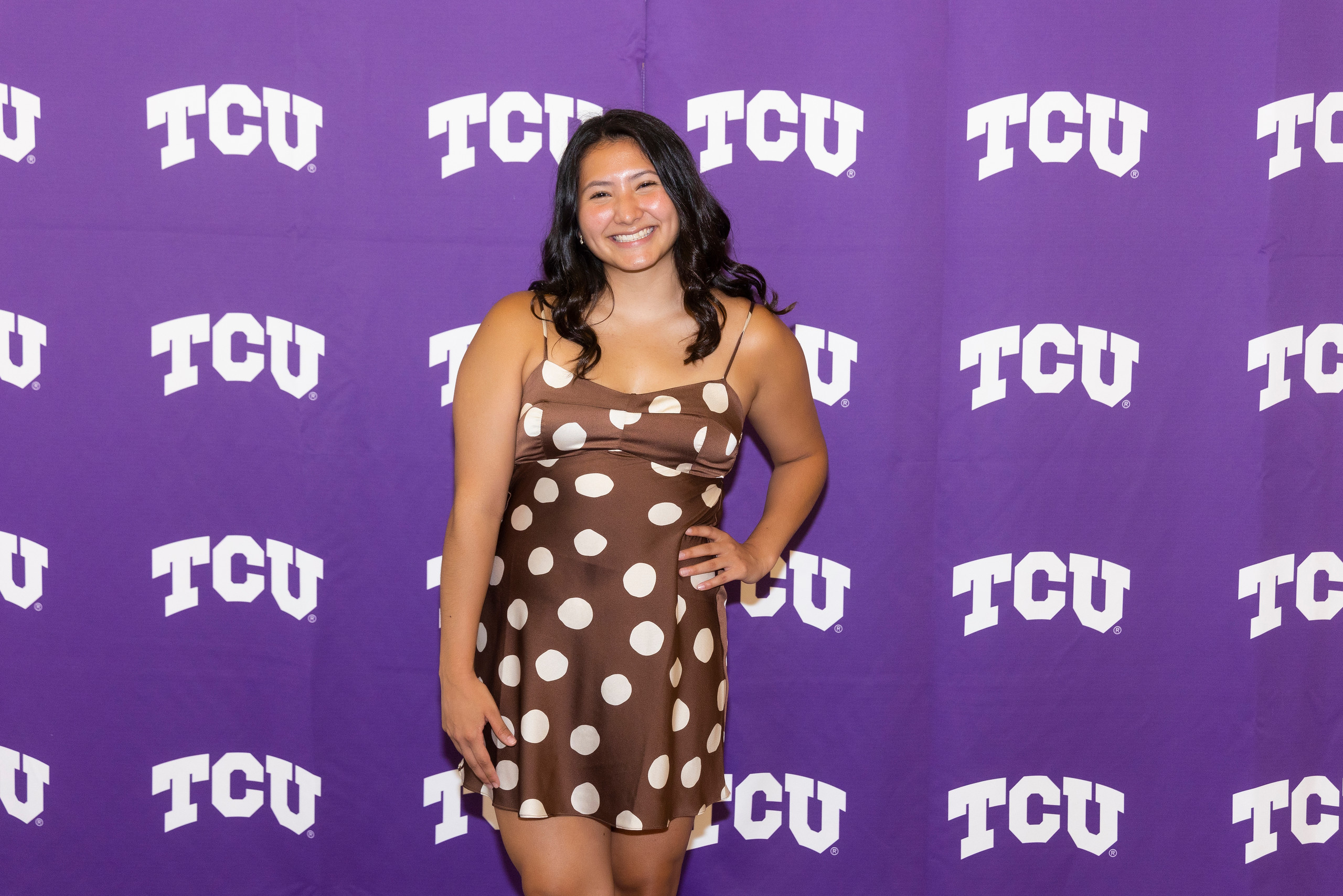 Gracie Liang posing in front of a TCU backdrop