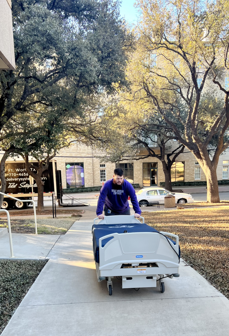 hospital bed being pushed on campus