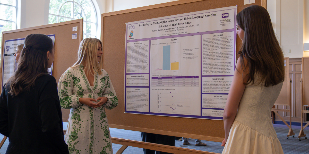 Harris College students presenting research poster during 2026 research competition.