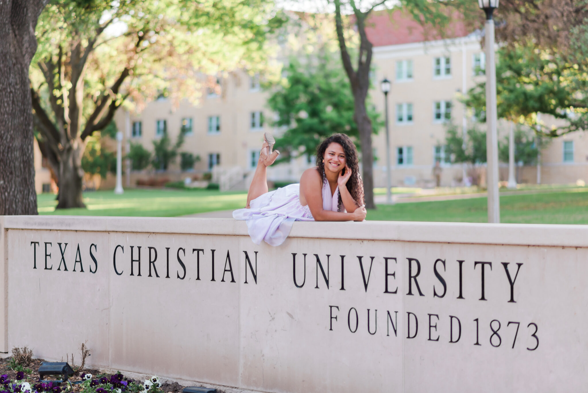 Suzanne Roudebush senior picture on the TCU sign